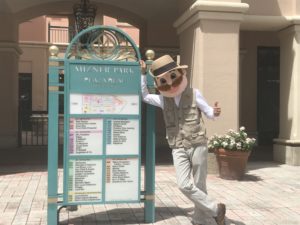 Gunther leaning on Mizner Park sign after mosquito treatment in Boca Raton