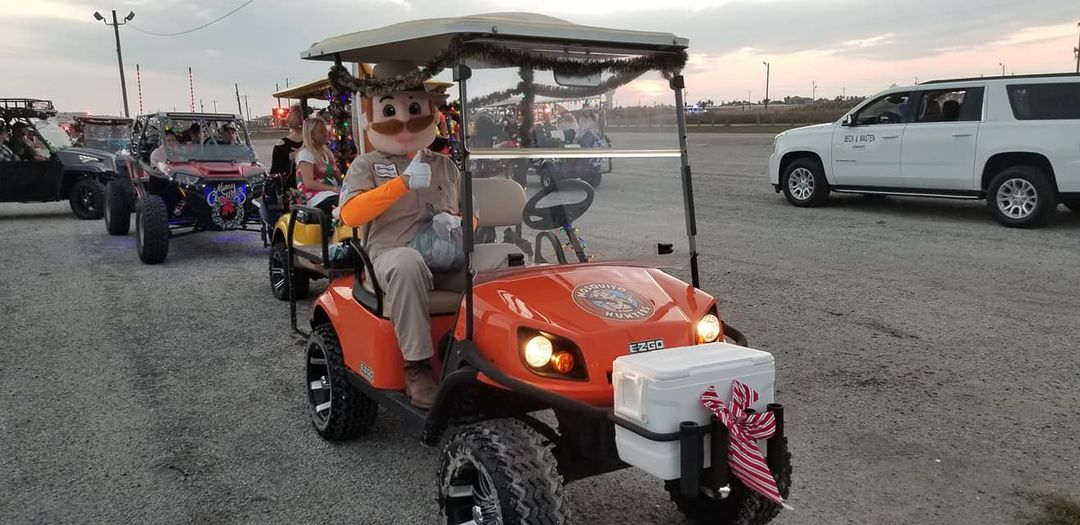 Gunther from Mosquito Hunters at Christmas Golf Cart Parade