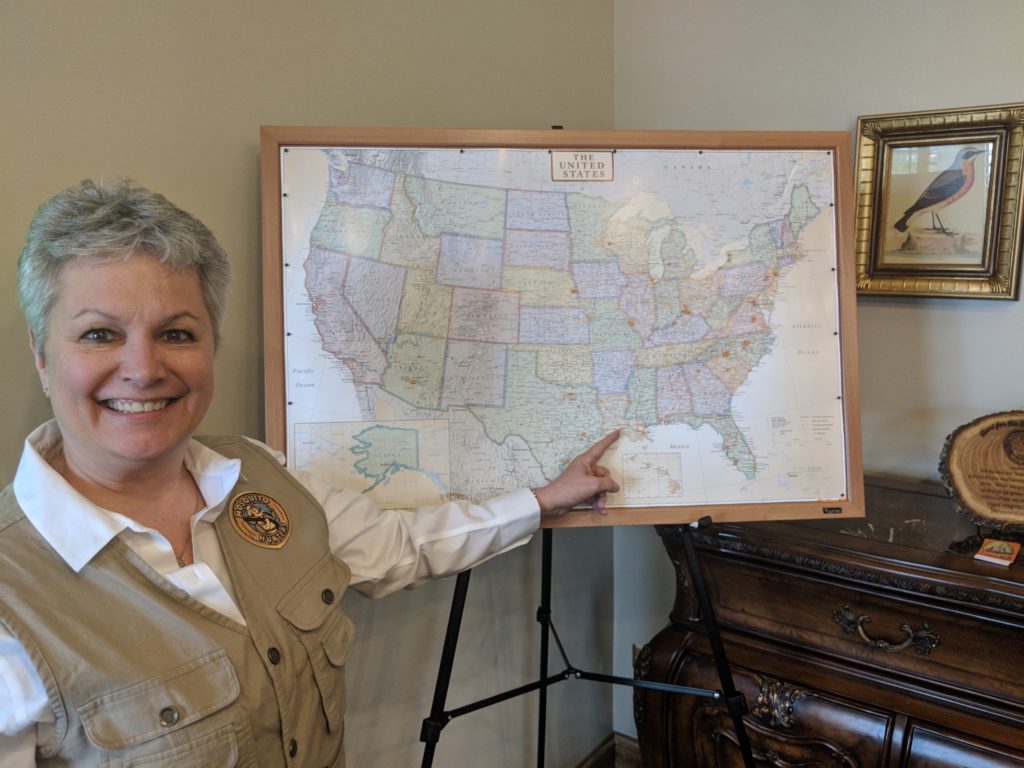 mosquito control owner Cindy H. standing with territory map