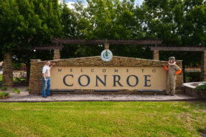 Local Mosquito Hunters of Conroe Owner Josh Davies in front of township sign